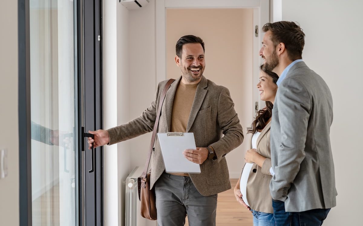 realtor showing an expecting couple a home