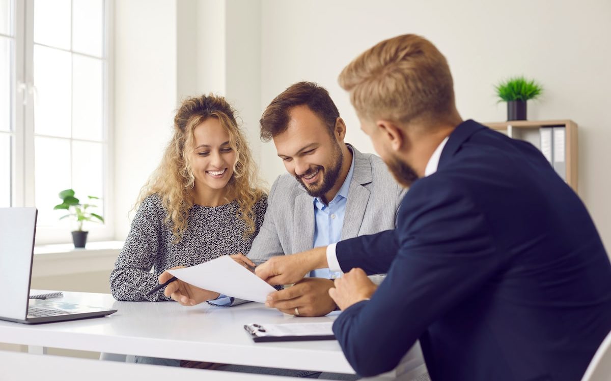 happy clients meeting with real estate agent