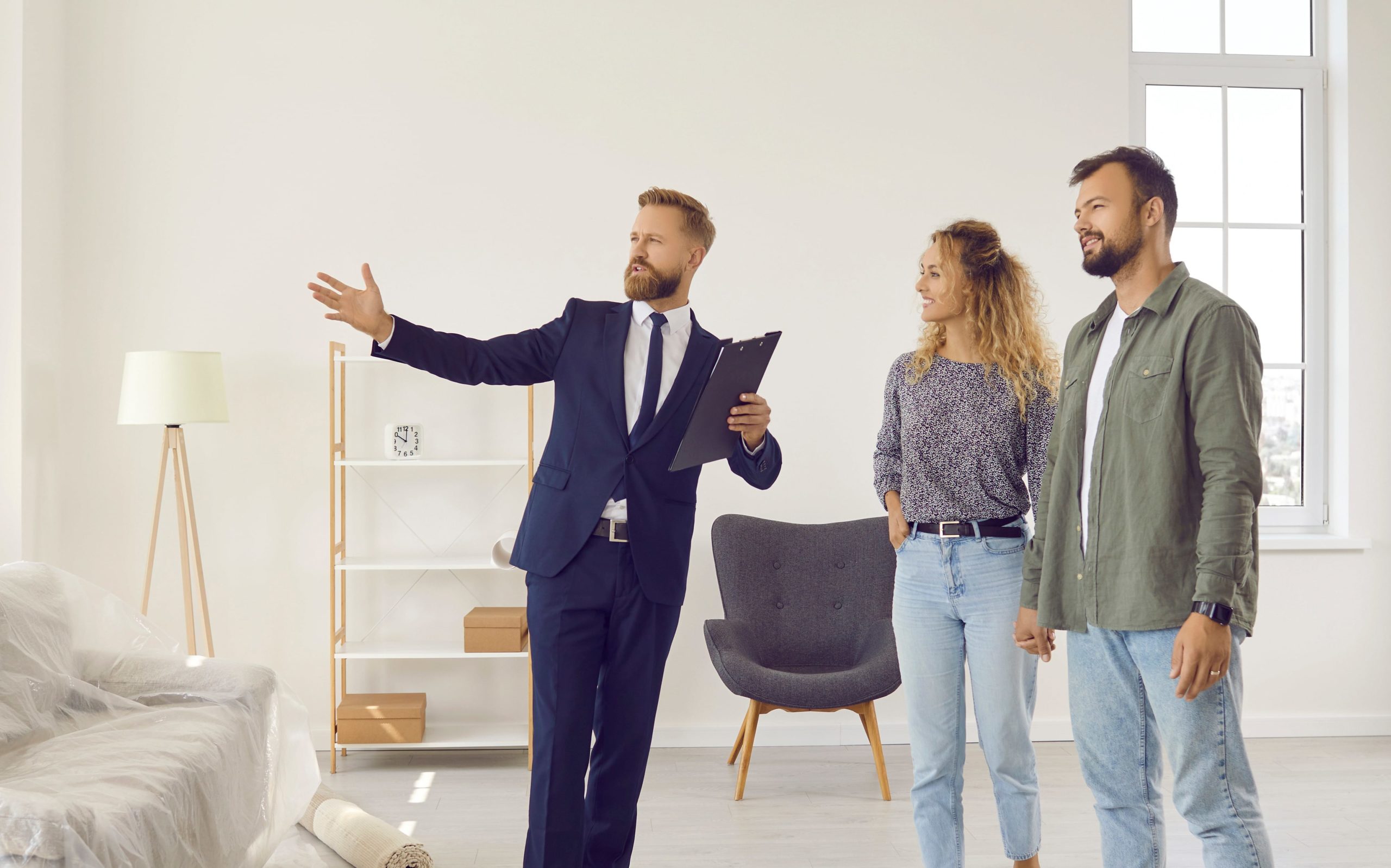 happy couple receiving guidance from real estate agent