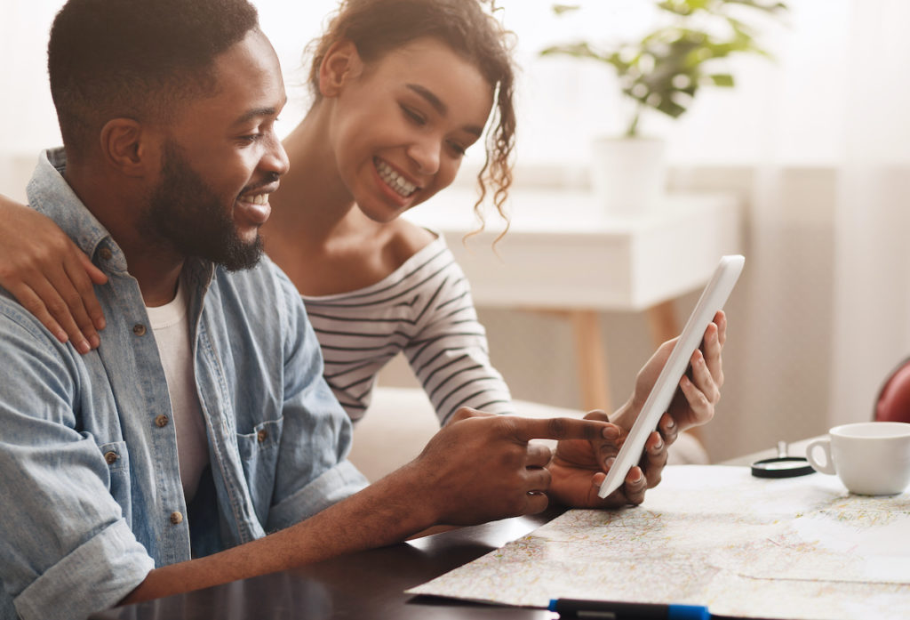 Couple using a tablet to search for a home