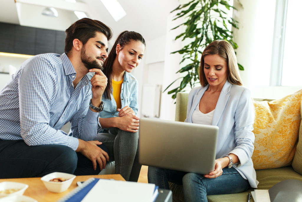 Couple getting a home valuation from an agent