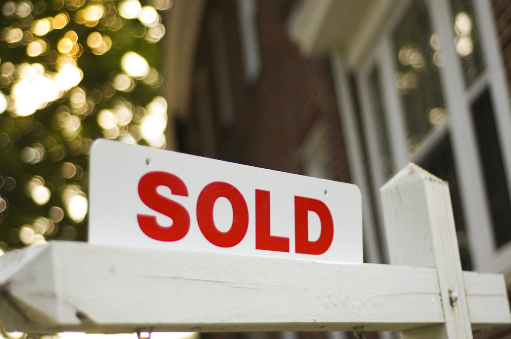 White sold home sign