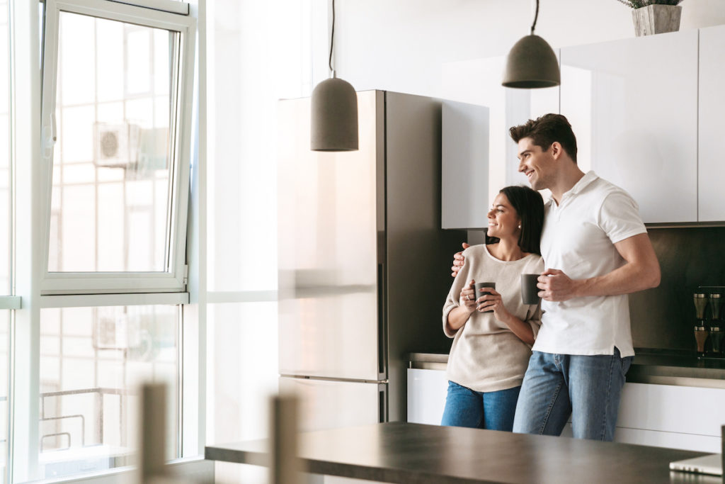 homeowners hugging in kitchen