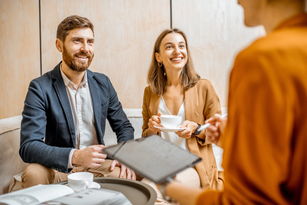 couple meeting with realtor over coffee