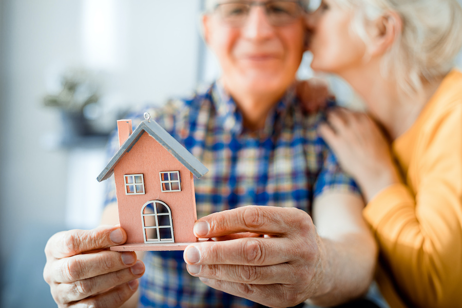 Senior adults holding a home