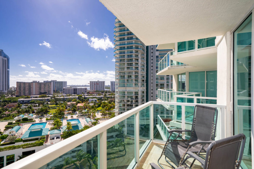 Image showing a luxury condominium overlooking several swimming pools.