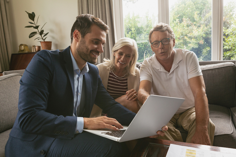 Image of a couple working with a real estate agent.