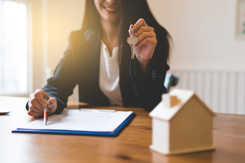 Realtor is giving the keys to a home to clients.