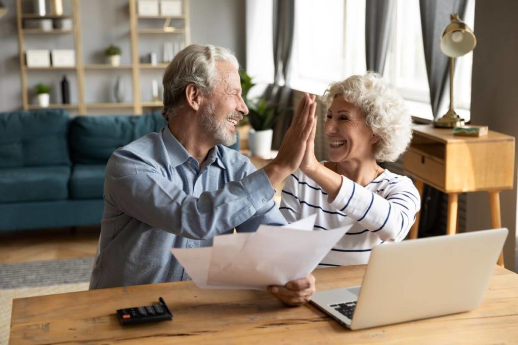 happy old couple on laptop
