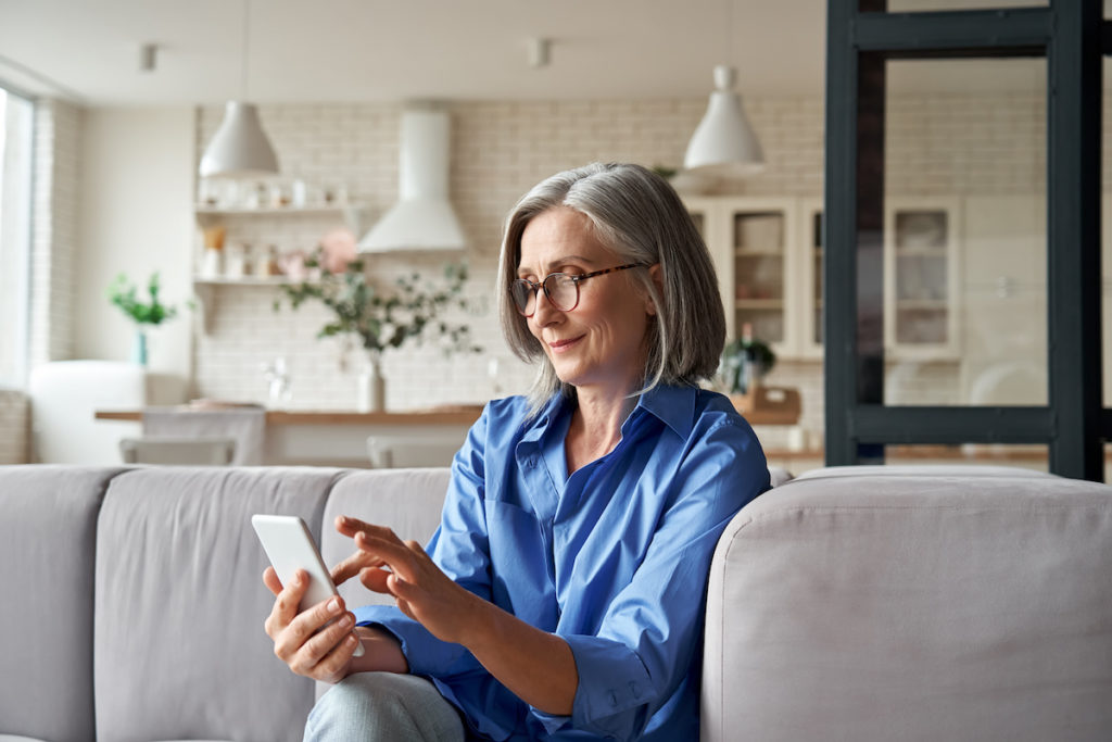 woman searching homes on phone