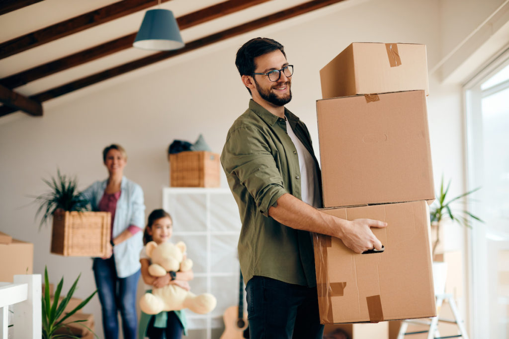 man moving boxes for family