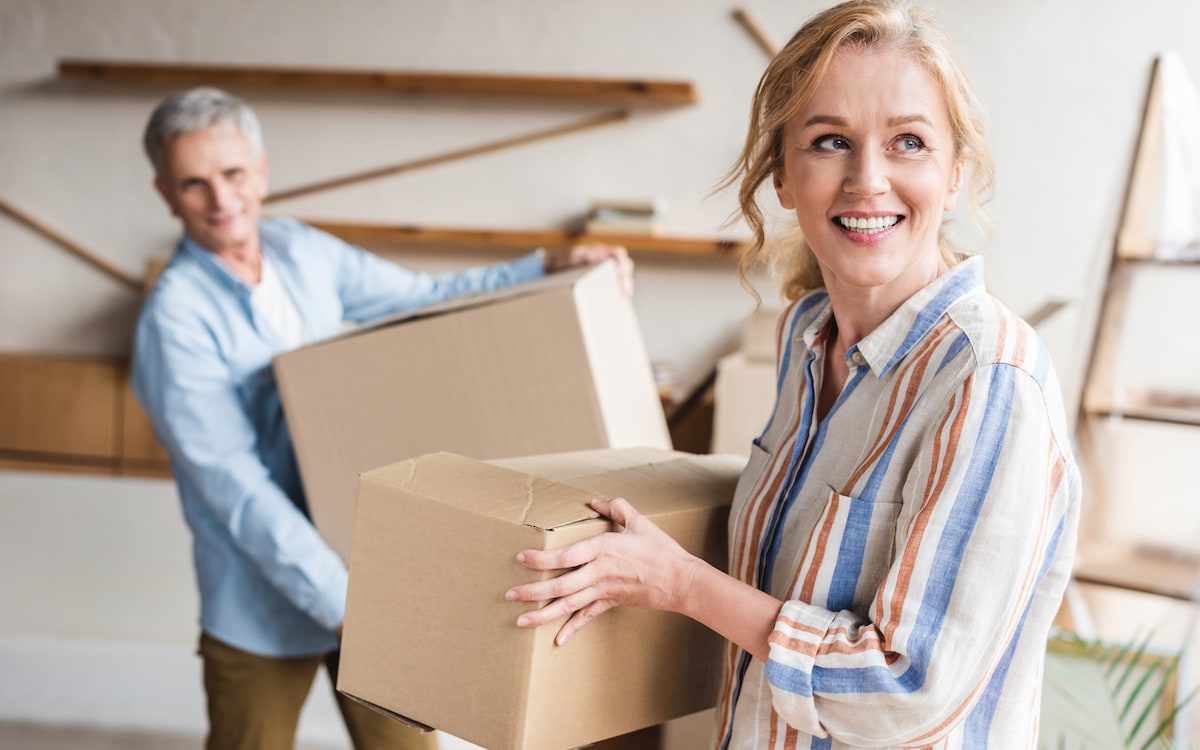 couple moving packing boxes