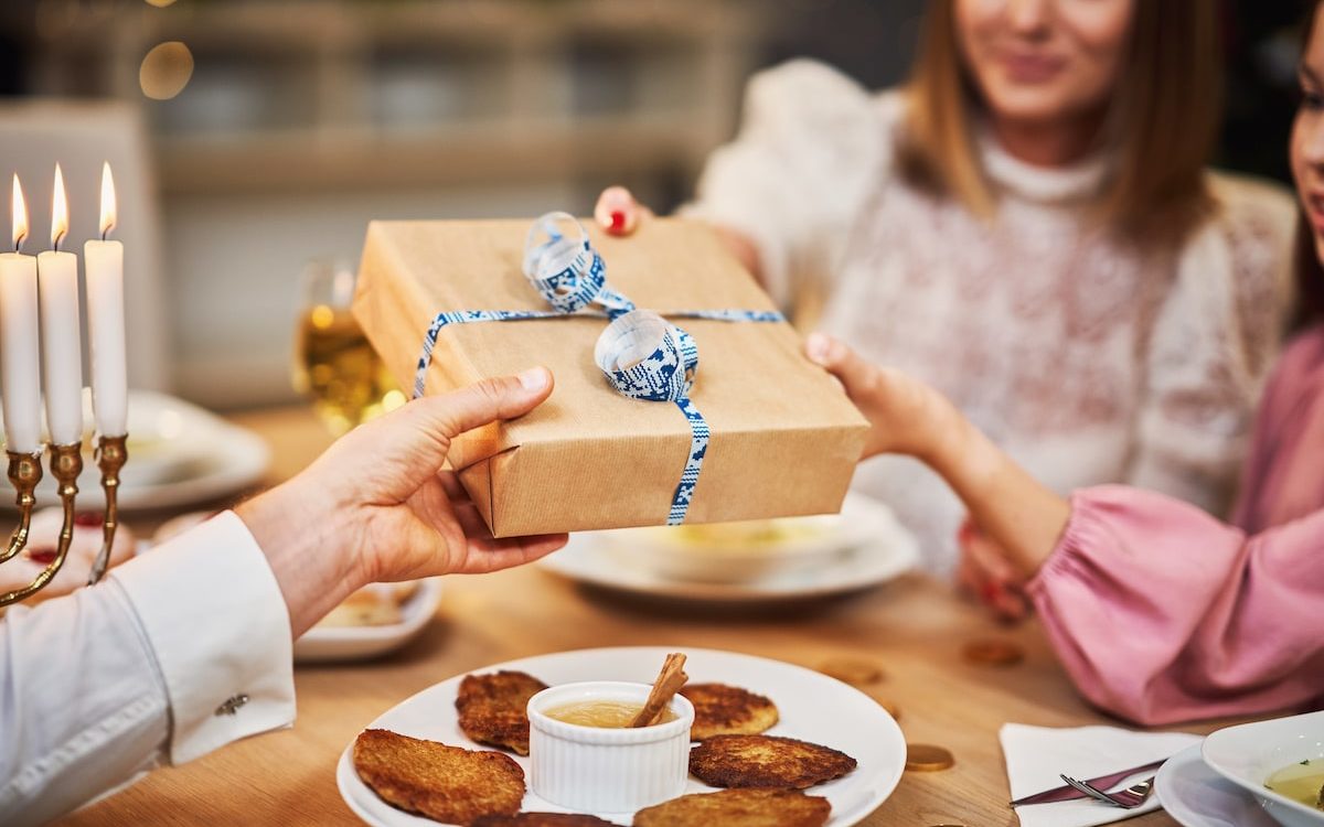 family giving hanukkah gift 