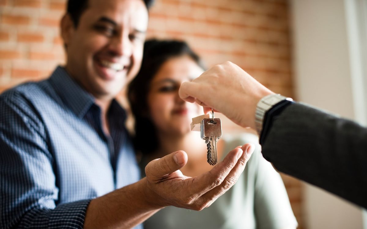 happy new homebuyers receiving house keys