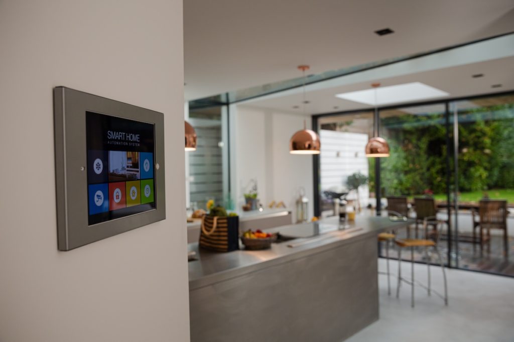 Close up of home alarm system with kitchen in background