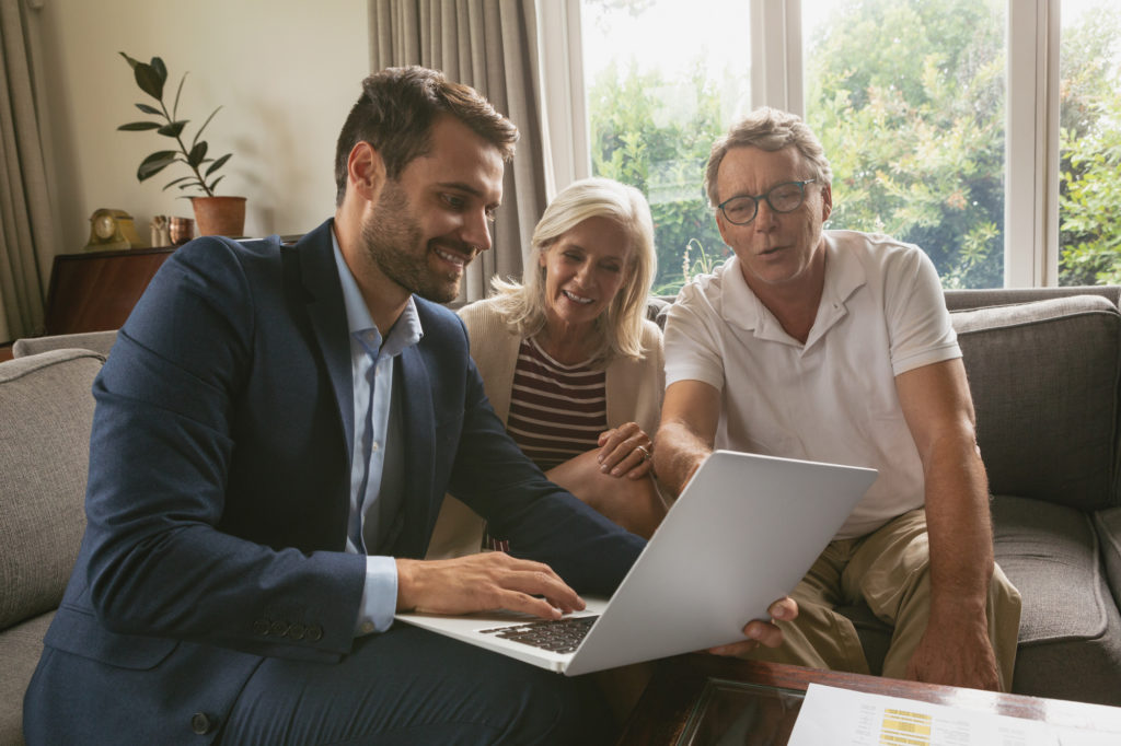 older couple working with a real estate agent