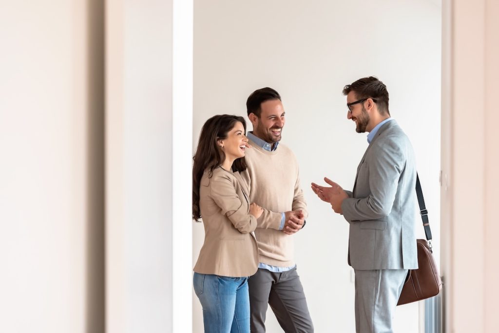 Couple and agent at open house