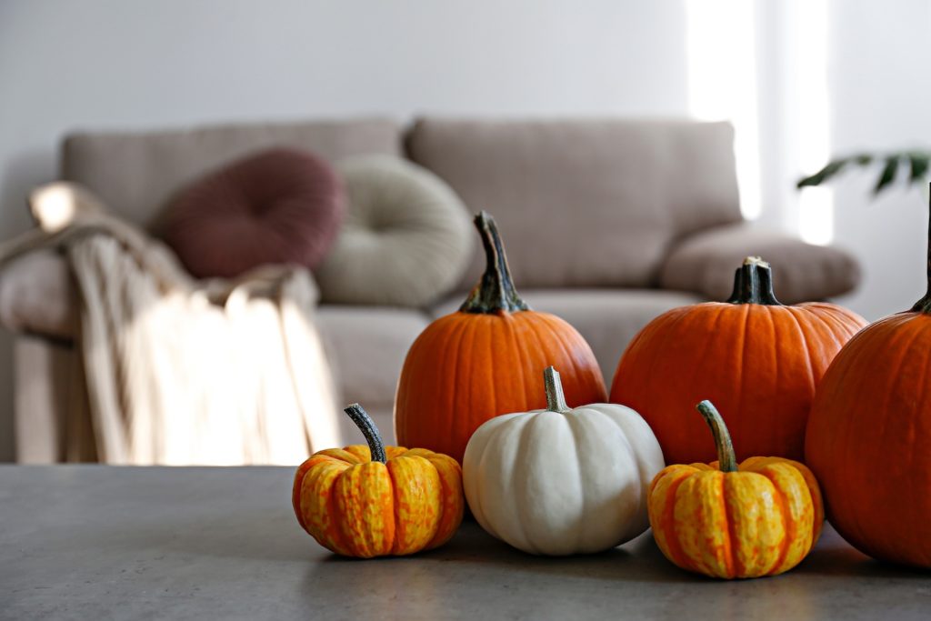 pumpkins on a table with a couch in the background